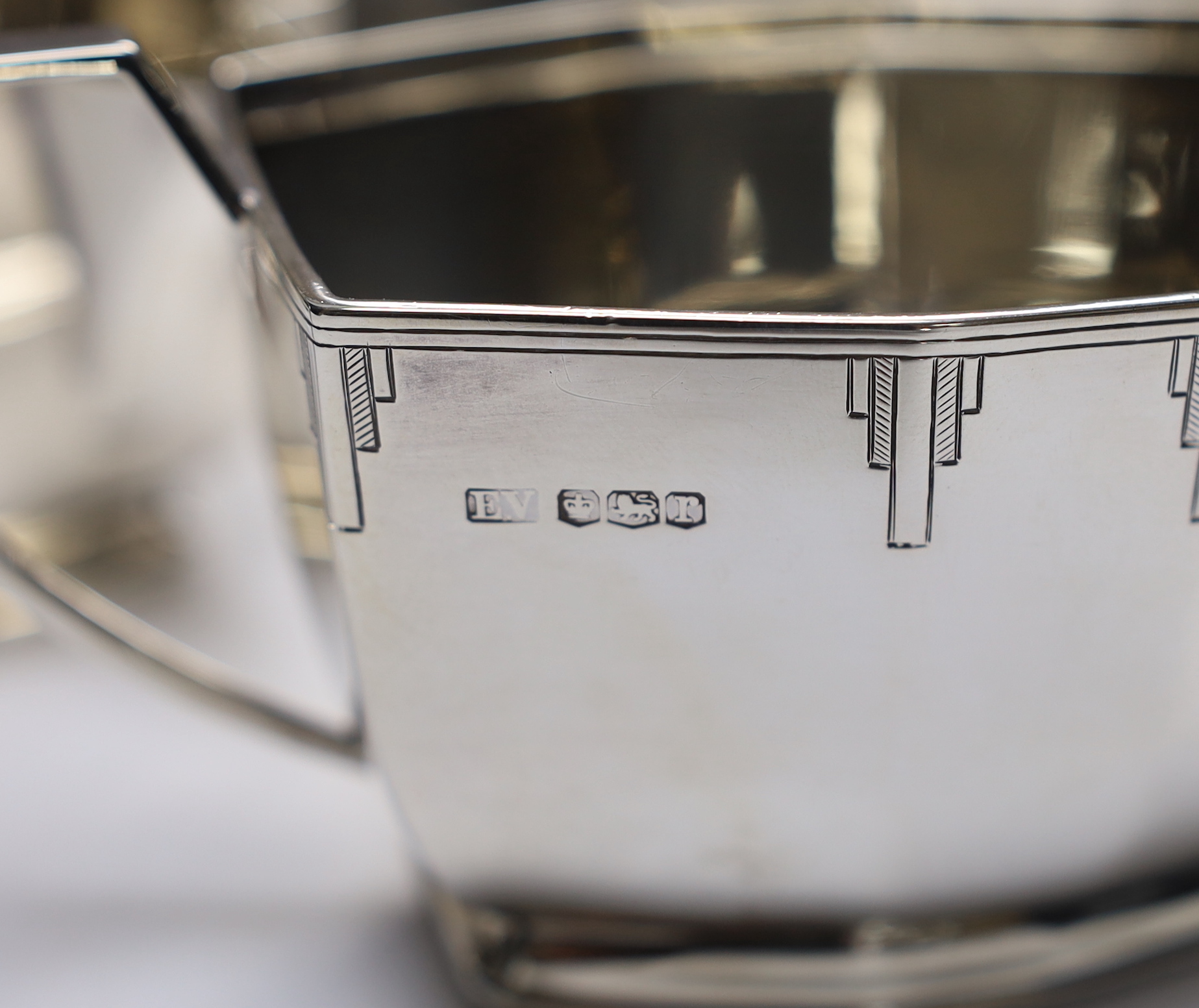 A George V Art Deco silver four piece tea set with tea tray, by Viners Ltd, Sheffield, 1934/36, 114.5oz. (lacking handles)